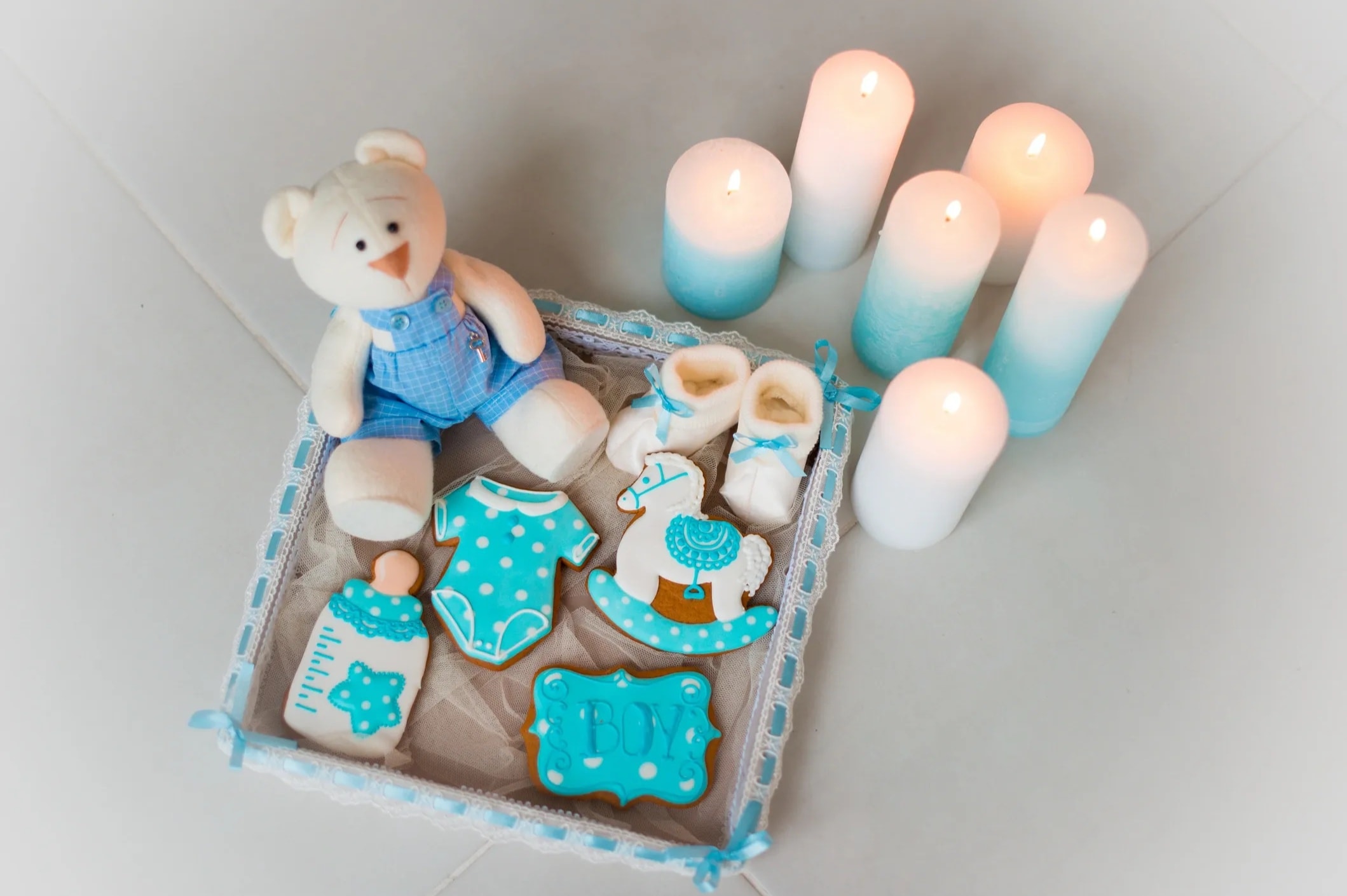 Baby onesie and teddy bear shaped decorated cookies