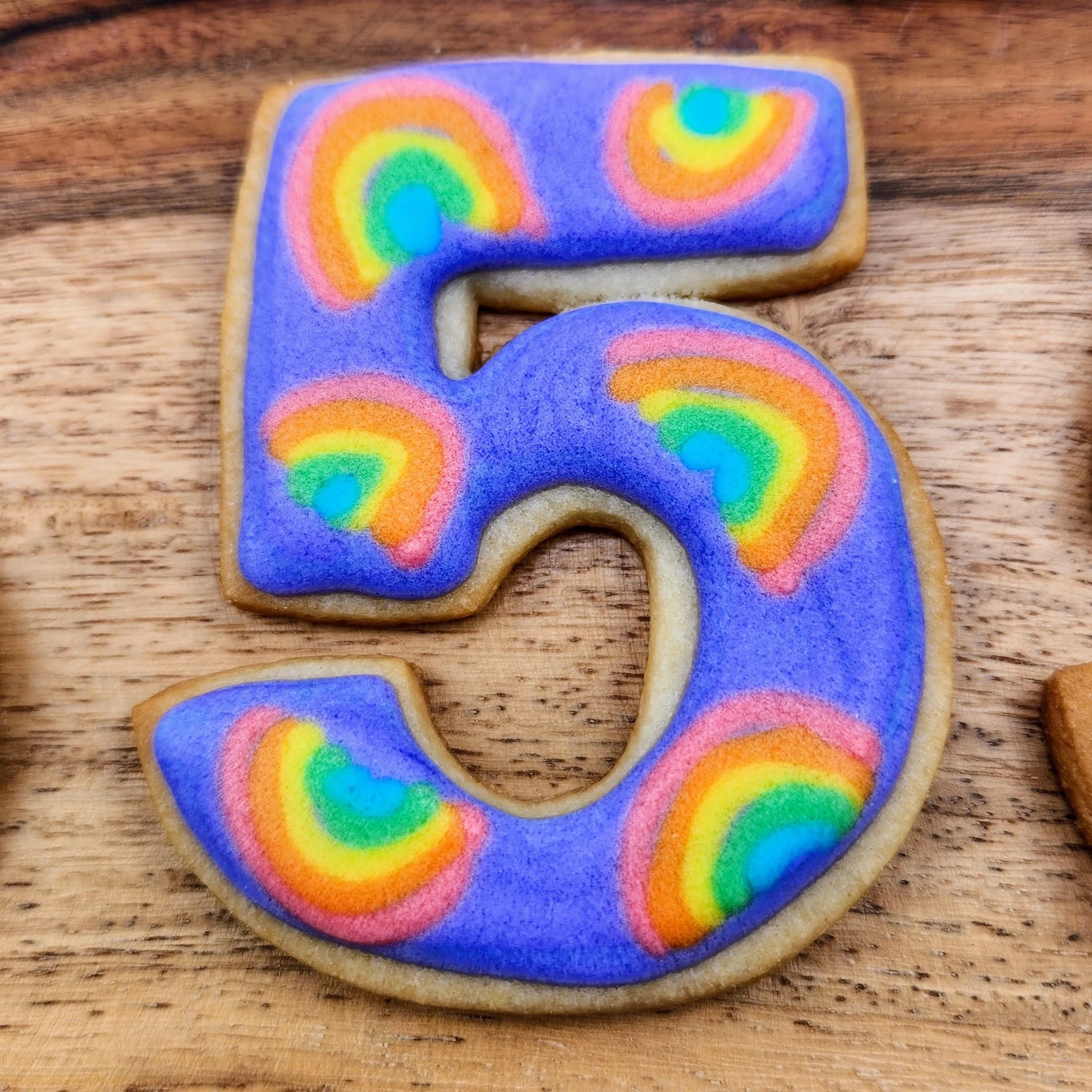 Colorful number-shaped birthday sugar cookies with pastel icing