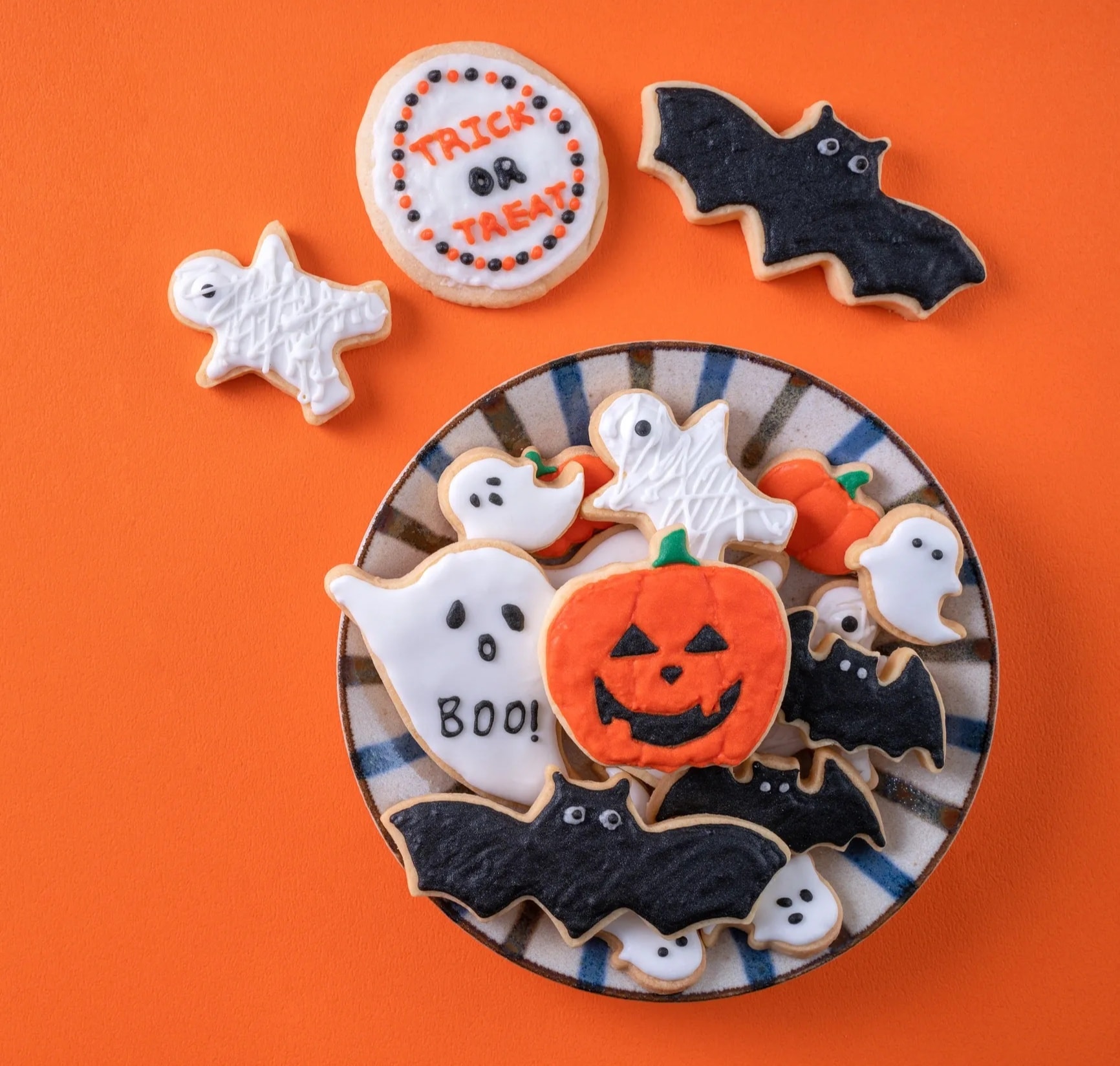 Halloween pumpkin and ghost decorated sugar cookies